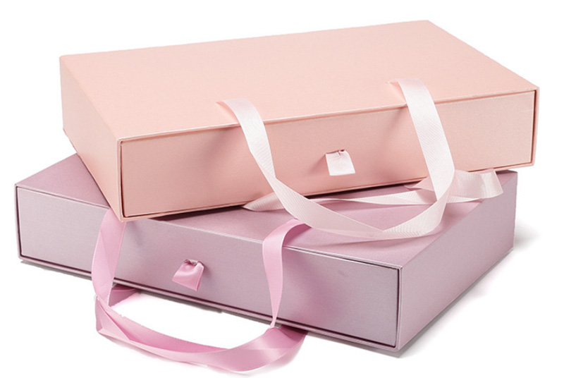 Foldable box with a convenient carrying strap